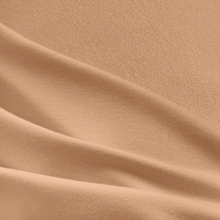 Close-up of beige viscose fabric texture with visible terry loops