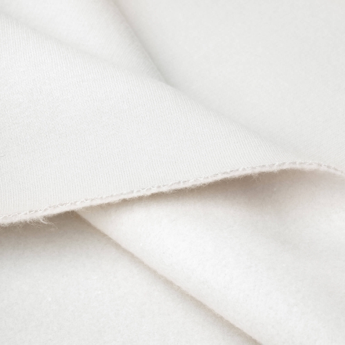 Zbliżenie struktury dzianiny bawełnianej drapanej w kolorze off white