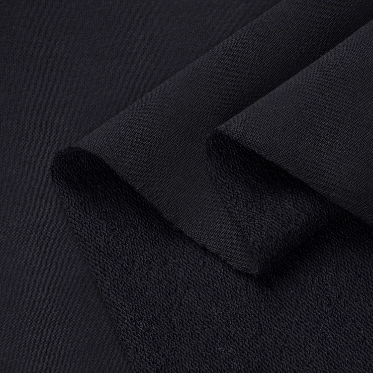 Black French Terry Cotton 280g – soft, medium-weight sweatshirt fabric in folds.