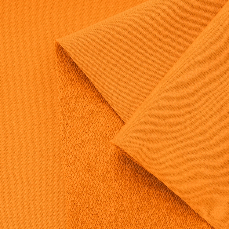 Close-up of orange fabric texture – soft and flexible terry fabric