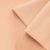 Close-up of light orange French terry knit – smooth front and looped back structure.