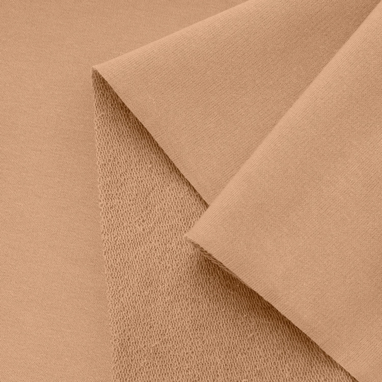 Close-up of beige terry knit – looped back and smooth front side detail.