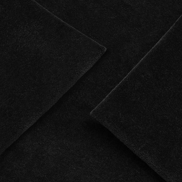 Smooth black velour knit – textile texture detail