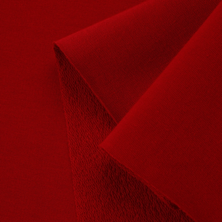Close-up of Red 29 fabric highlighting the diagonal loopback texture and smooth knit front