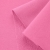 Close-up of Pink 51 fabric highlighting the diagonal loopback knit on the reverse and the smooth outer layer