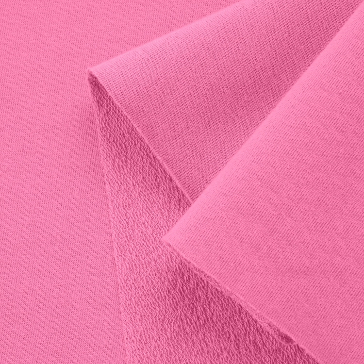 Close-up of Pink 51 fabric highlighting the diagonal loopback knit on the reverse and the smooth outer layer