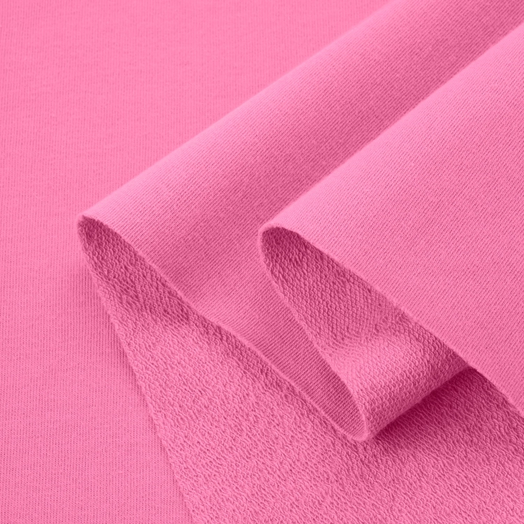 Layered bright pink terry fabric showing elasticity, thickness, and looped structure on the inner side