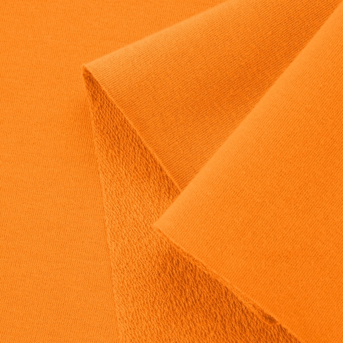 Close-up of the Orange 163 knit – smooth face and classic loopback structure for comfort and breathability.