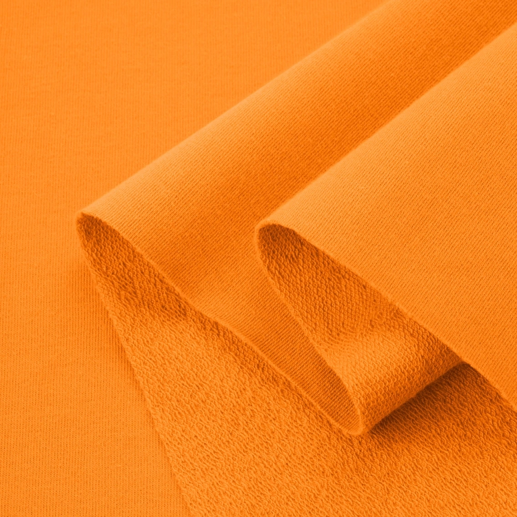 Folded Orange French terry fabric – soft, stretchy, and perfect for children’s clothing, sweatshirts, and accessories.