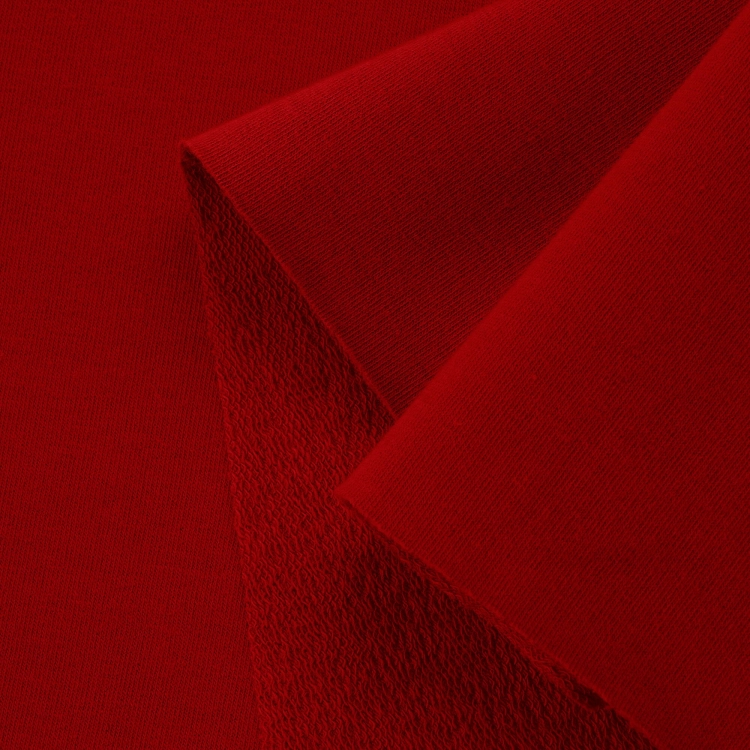 Close-up of Red 29 fabric – smooth right side with visible looped backing for comfort and stretch.