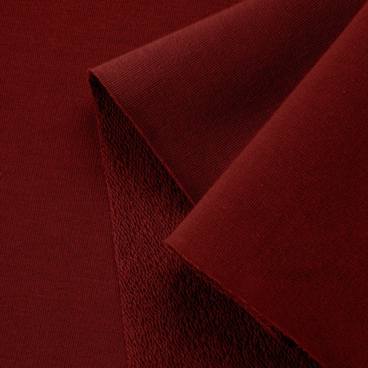 Close-up of the fabric structure – smooth front and soft looped texture on the reverse side.