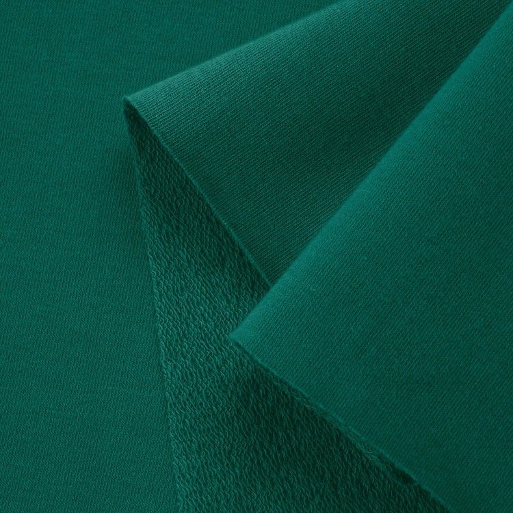 Close-up of Green 457 knit fabric – smooth surface and looped reverse for flexibility and comfort.