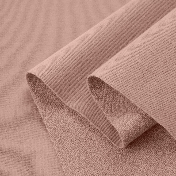 Folded Beige 553 fabric – soft, elastic knit with a warm nude hue.