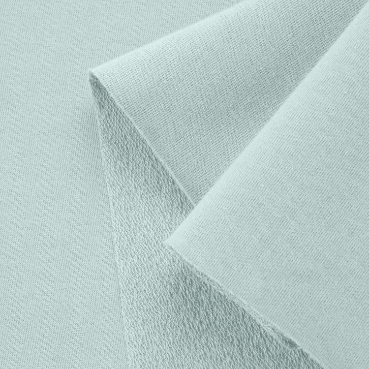 Close-up of Green 23 knit – smooth front side and textured loopback.