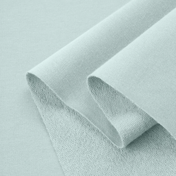 Folded Green 23 fabric – soft, elastic cotton in a calm, fresh shade.