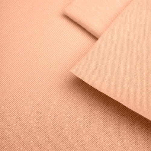 Close-up of orange knit fabric – visible fine texture and even color.