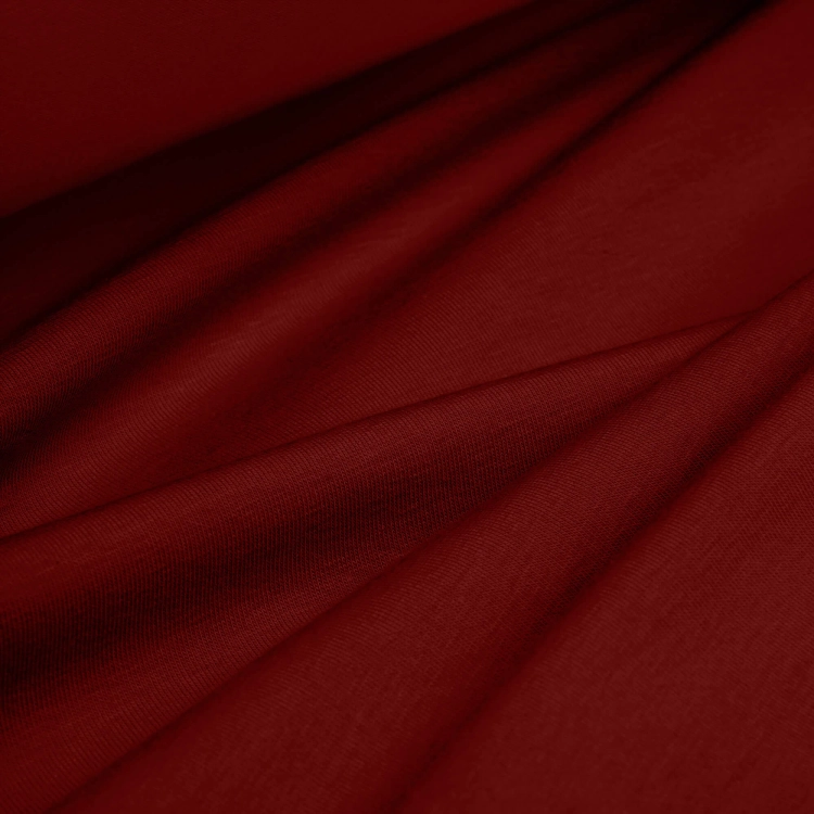 Folds of Bordo 266 fabric – soft, stretchy fabric in a warm, elegant red tone.