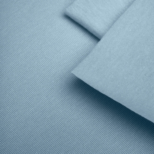 Close-up of Blue 564 fabric texture – fine single jersey in a muted pastel blue.
