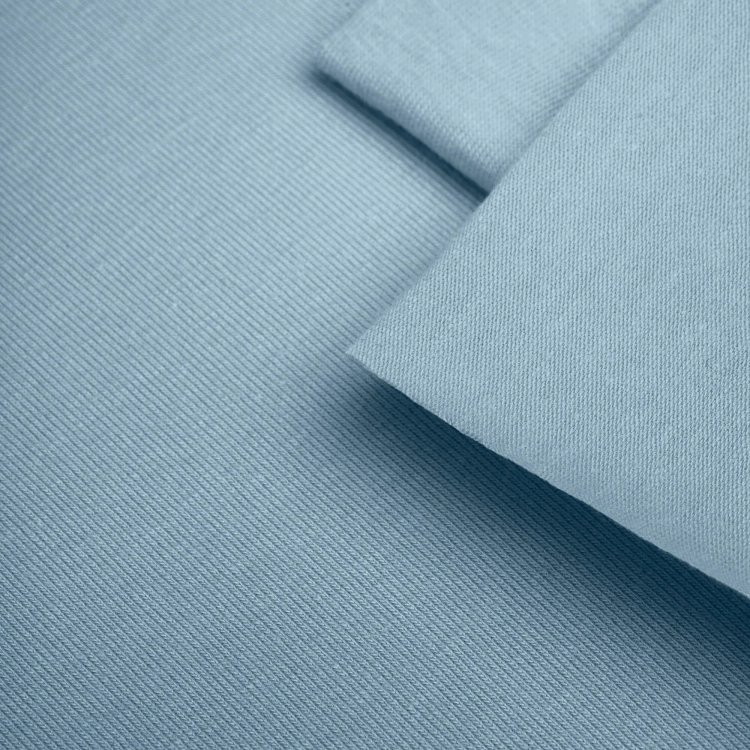Close-up of Blue 564 fabric texture – fine single jersey in a muted pastel blue.