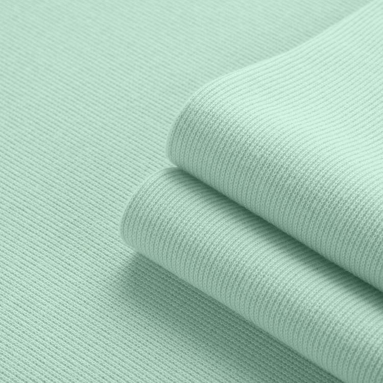 Close-up of green ribbed knit fabric texture