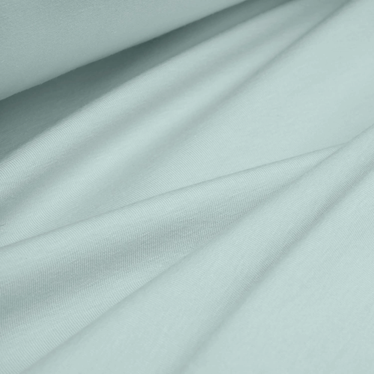 Single Jersey Cotton 160g green fabric – soft, elastic fabric surface arranged in folds