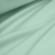 Draped mint green cotton jersey fabric showing its stretch and smooth texture