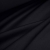 Draped folds of black cotton jersey fabric highlighting its softness and flexibility.